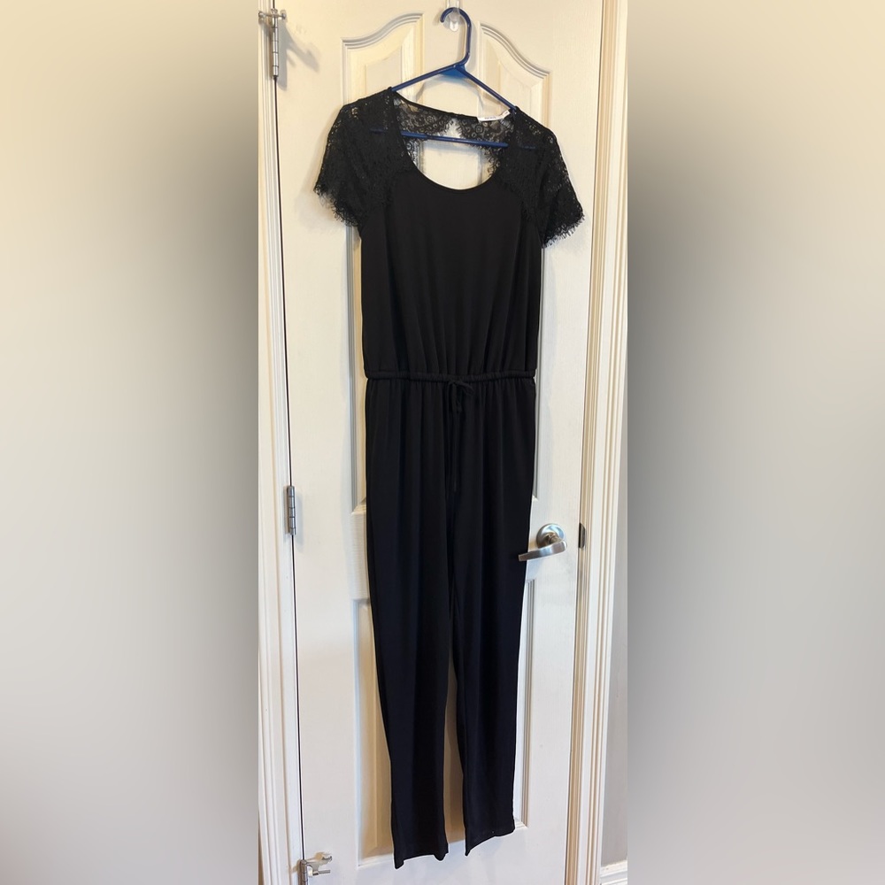 Ricki’s black jumpsuit with lace shoulder details - size small